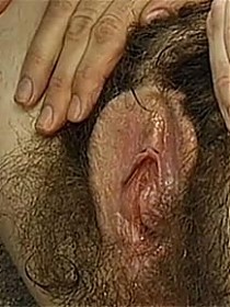 This mature amateur woman has a massively huge bush between her legs